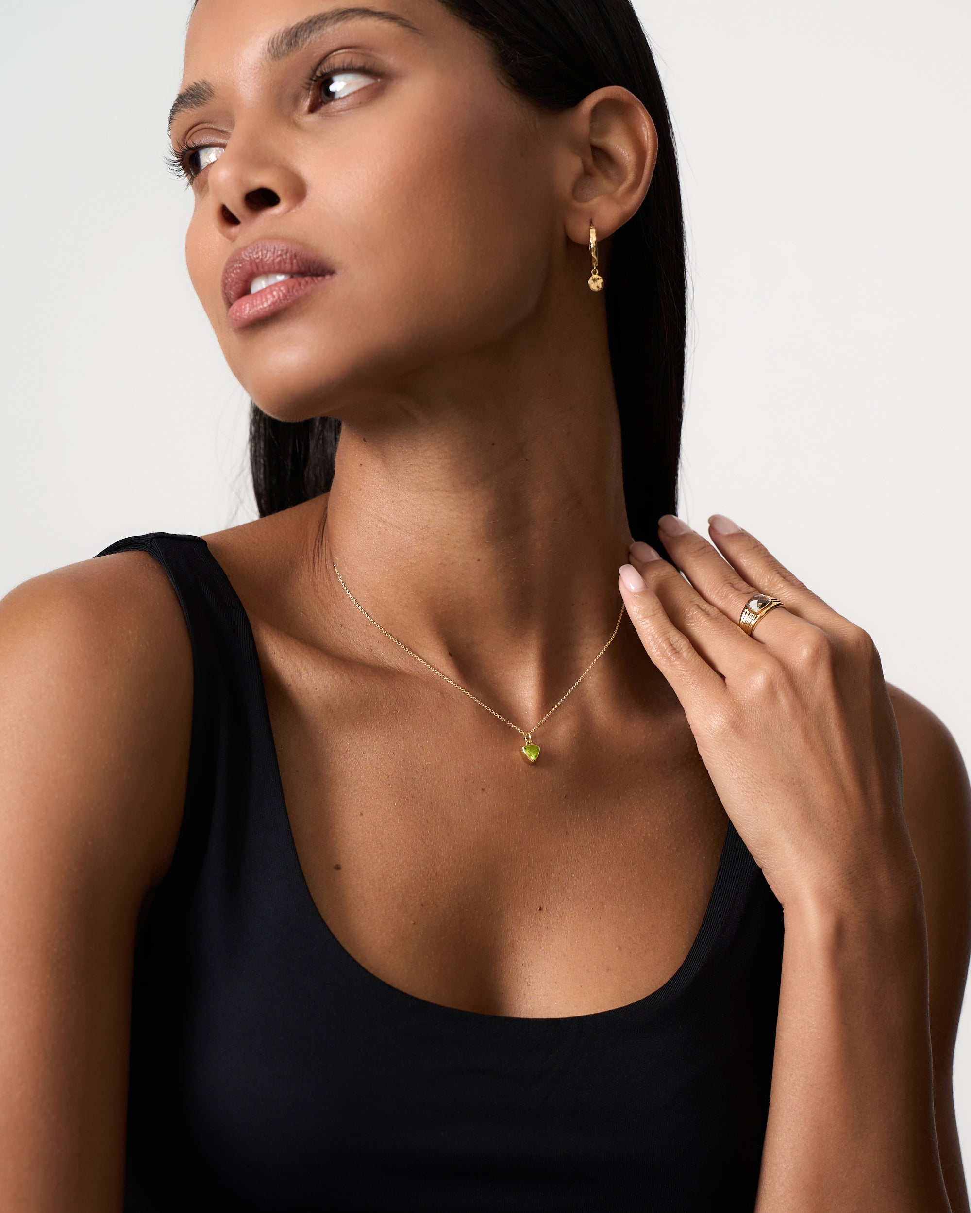 Model wearing Azora gold vermeil peridot August birthstone pendant