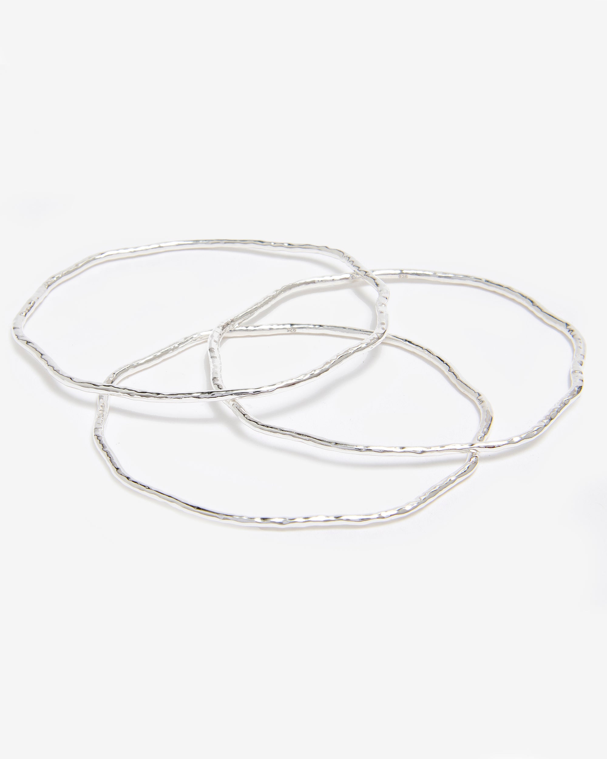 Set of three hammered silver bangles by Azora Jewellery