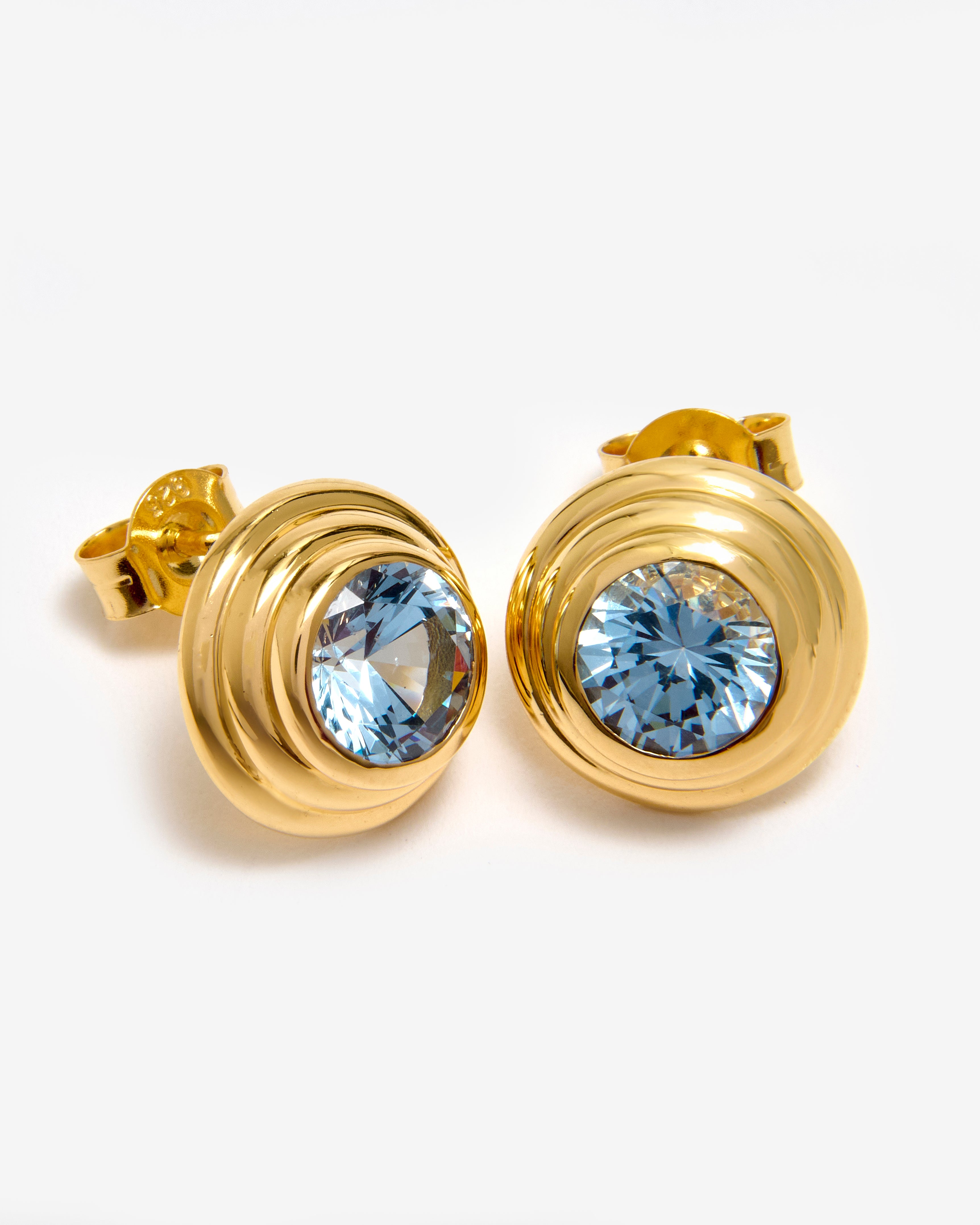 A pair of aquamarine gemstone stud earrings in a solarium setting of 18K gold vermeil by Azora.