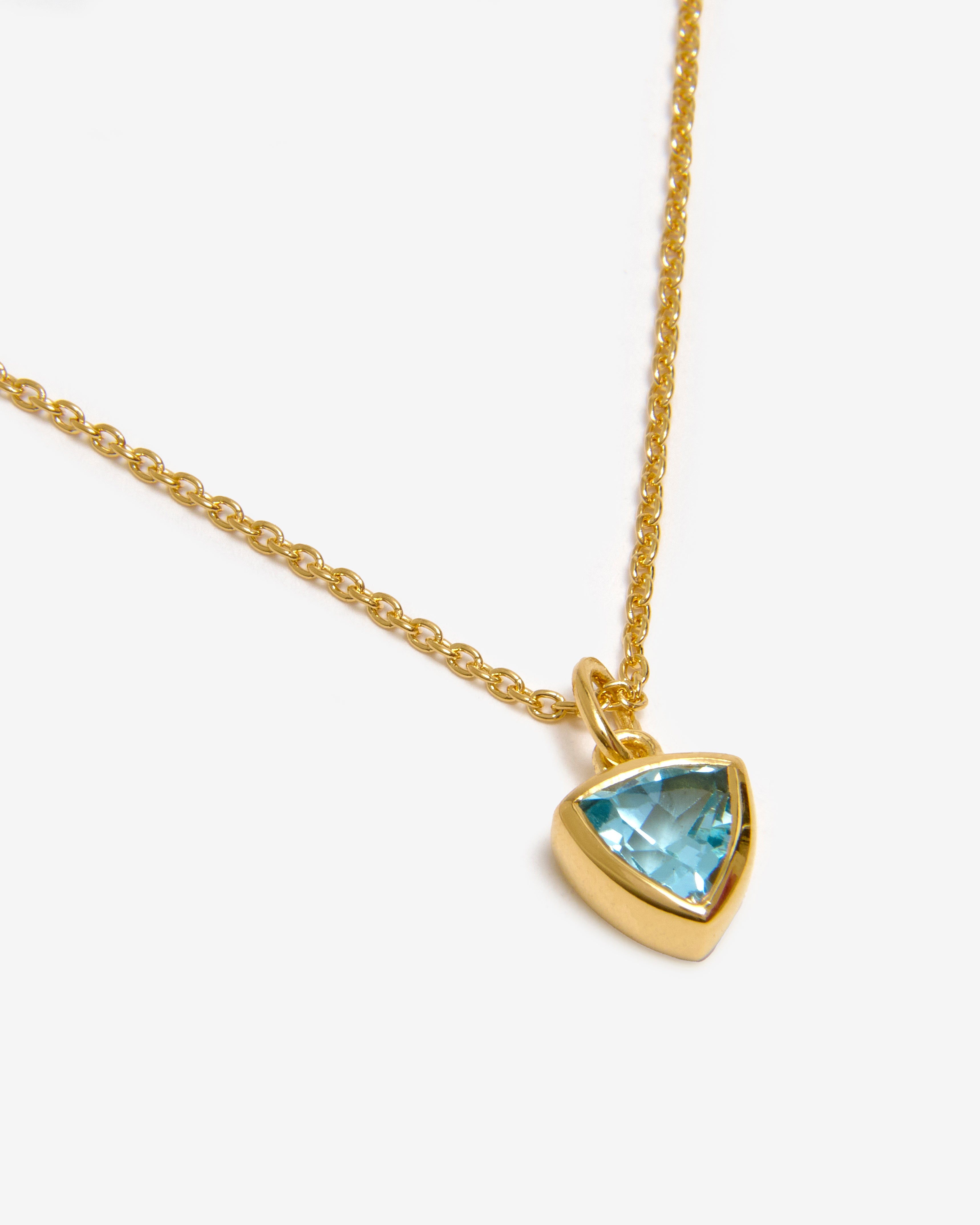 Azora gold vemeil December birthstone necklace with trillion-cut lab-grown blue topaz pendant