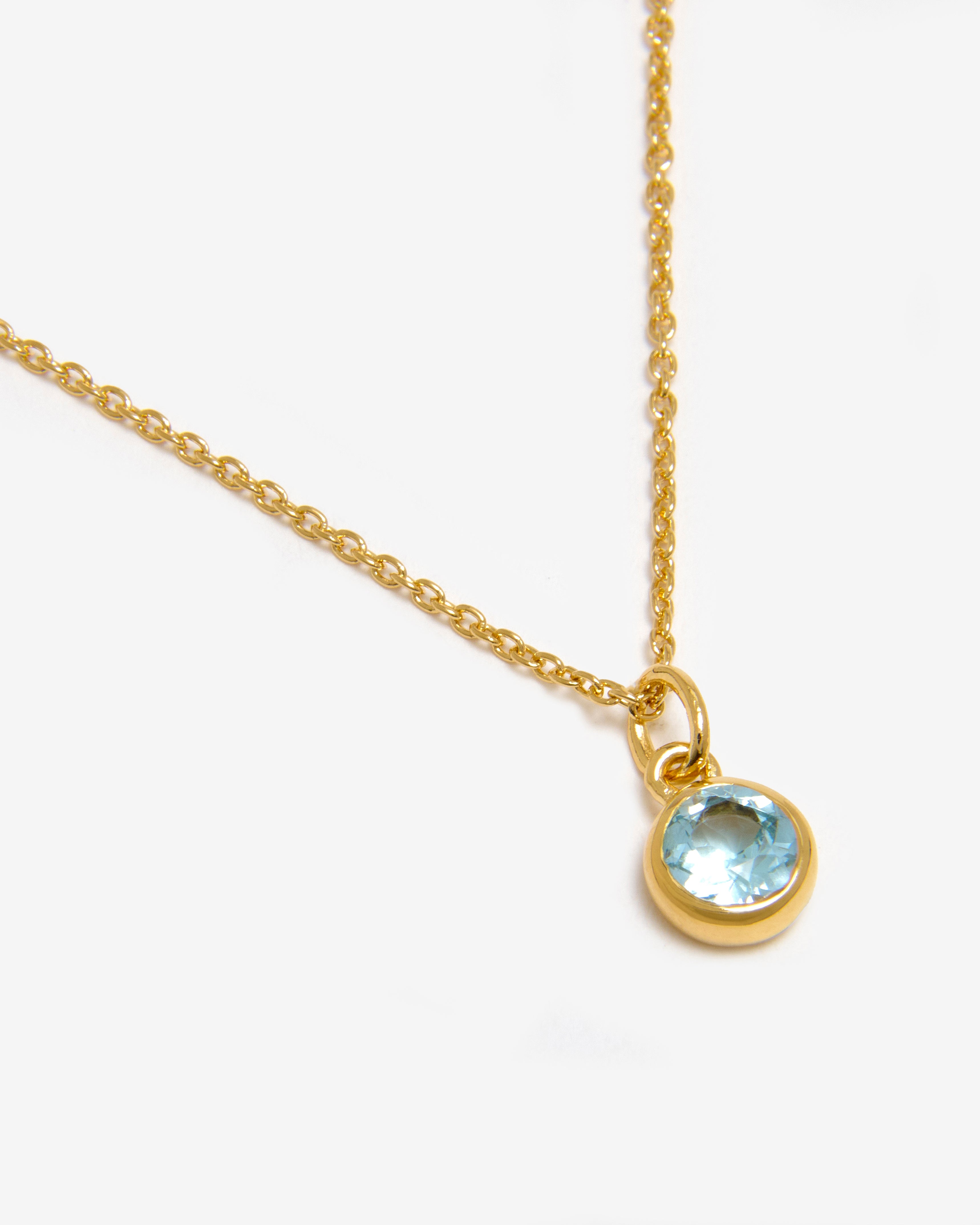 Azora gold vermeil December birthstone necklace with round-cut lab-grown blue topaz pendant