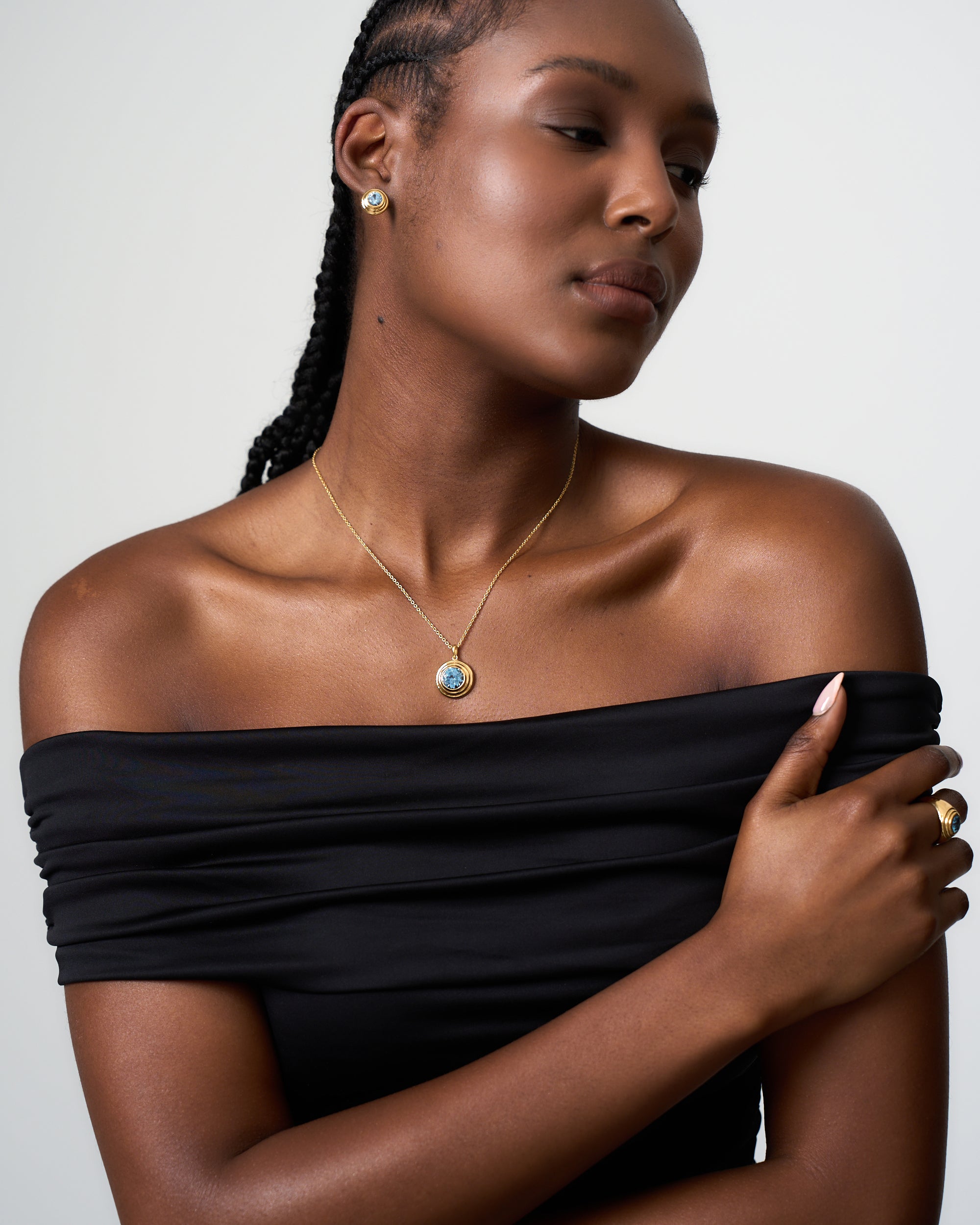 Model wears an aquamarine solarium necklace by Azora Jewellery