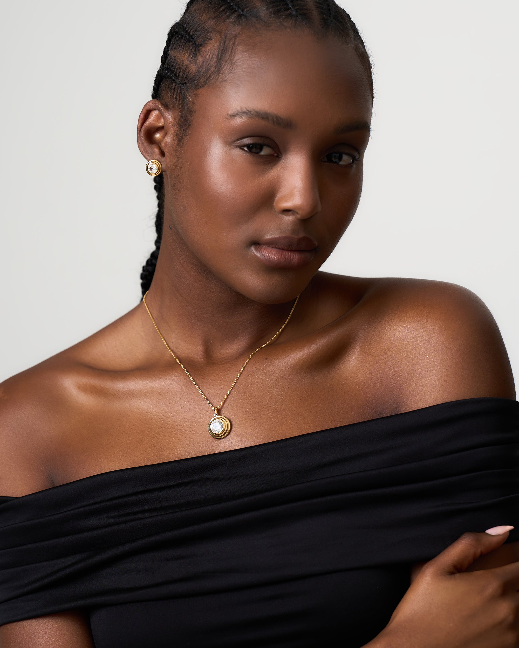 Model wears Azora Jewellery white sapphire gold vermeil pendant