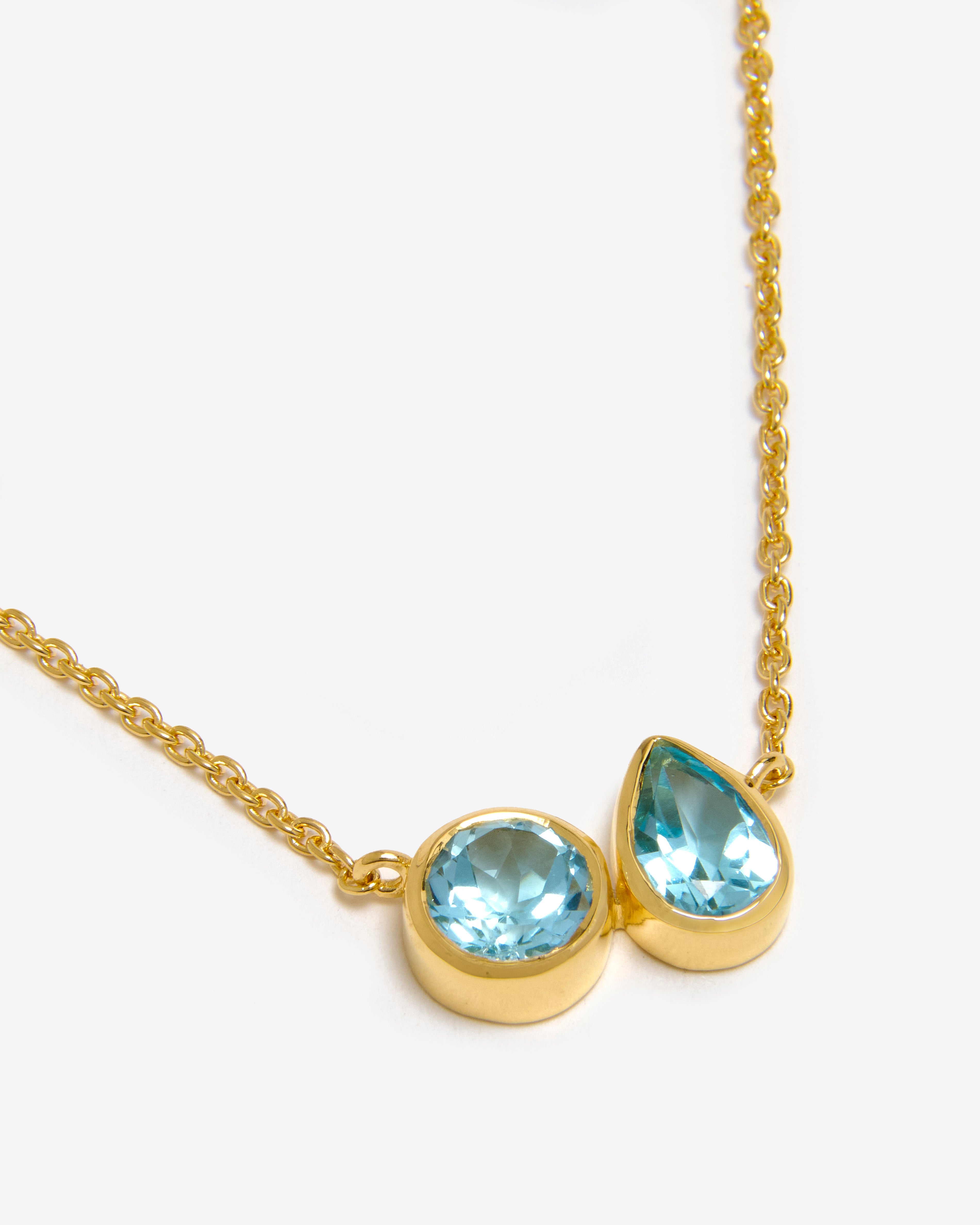 Blue topaz cluster necklace in 18ct gold vermeil on white background