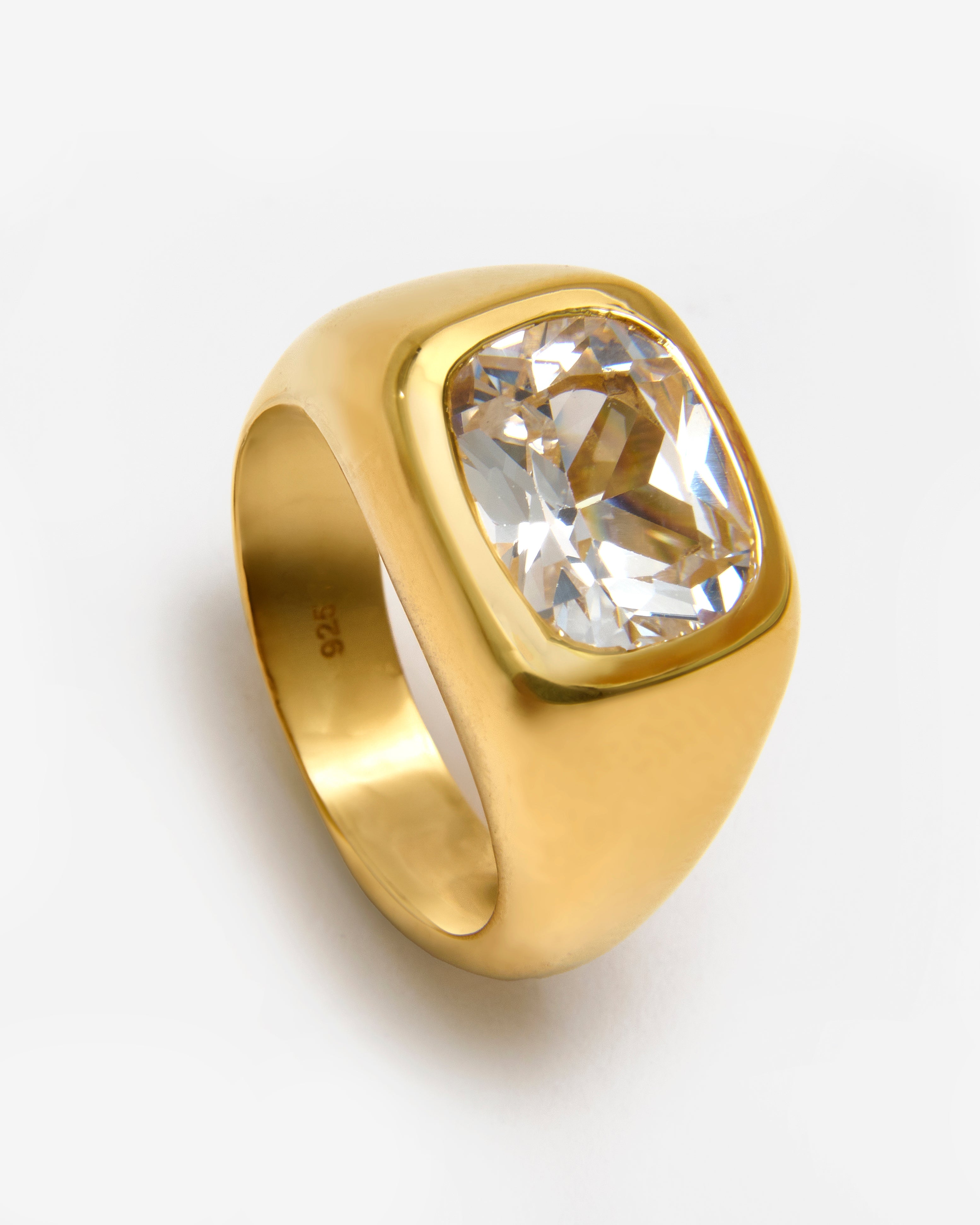 Gold vermeil chunky ring with a bezel-set white sapphire on a smooth domed band.